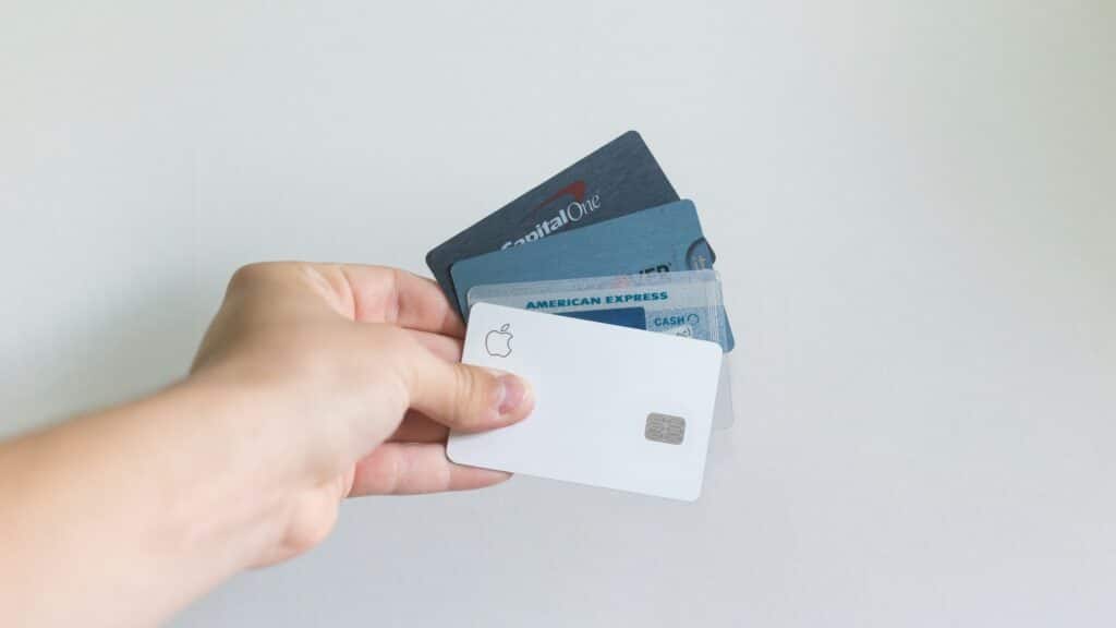 Man holding a range of US bank issued credit cards